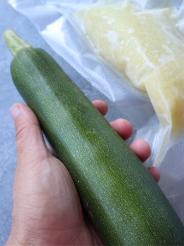 hand holding zucchini