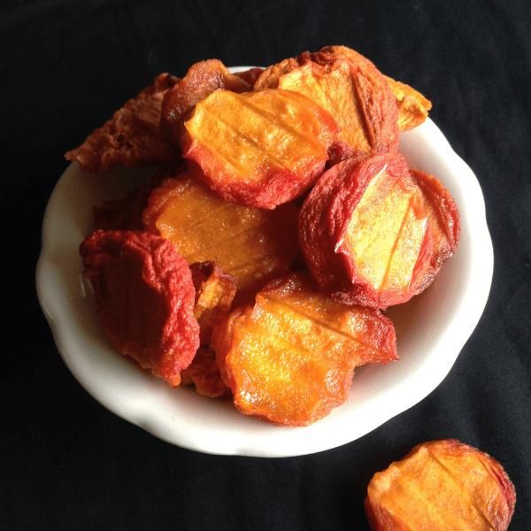 perfectly dried peaches in a dehydrator