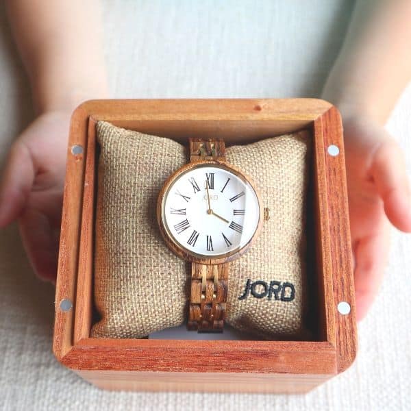 wooden watch being held by child