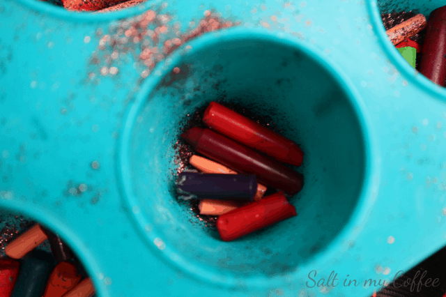 broken bits of crayon and glitter in mold for melting into crayon ornaments