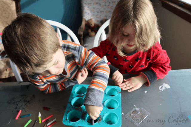 kids using broken ornaments to make crayon ornaments