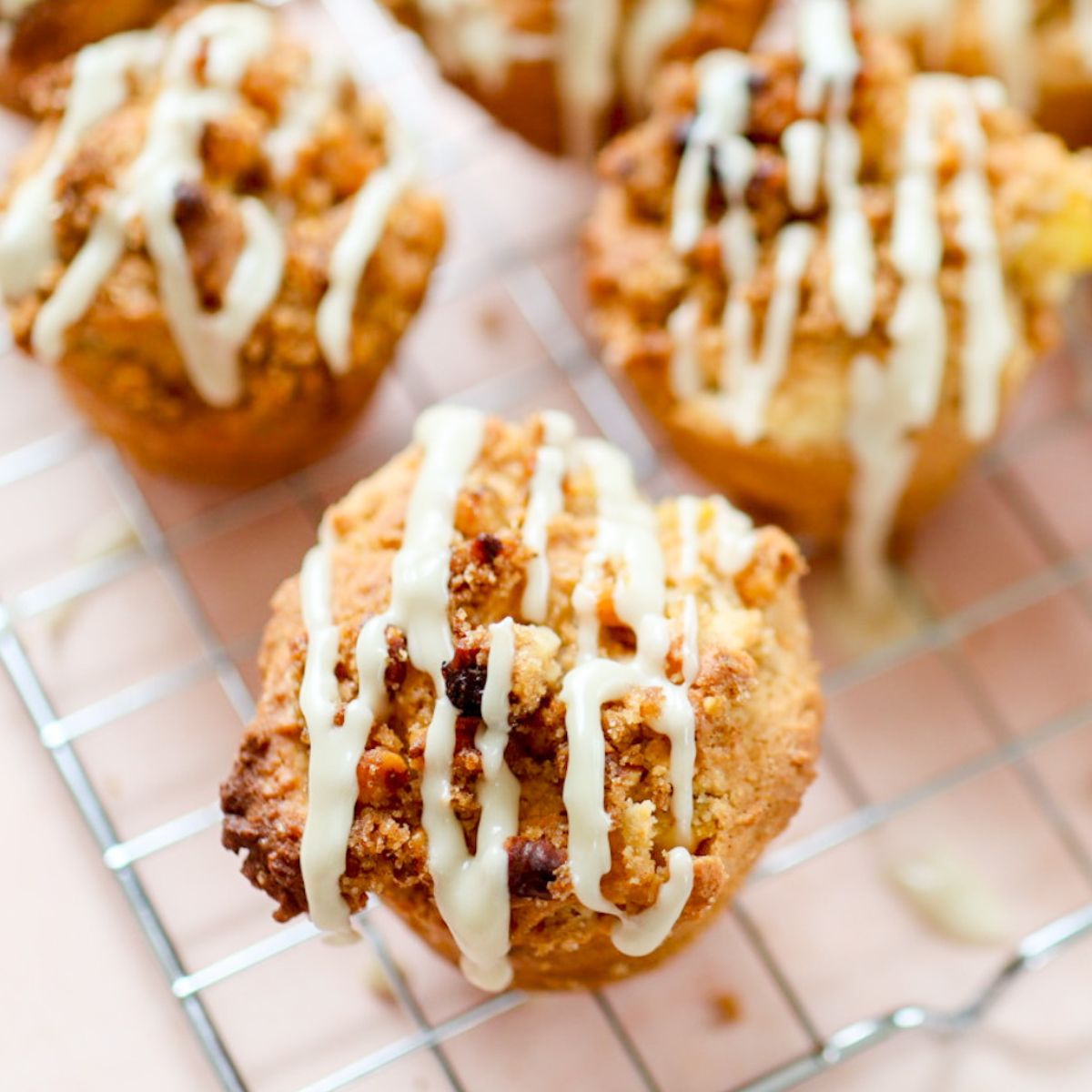 mango muffins with streusel topping and maple drizzle cool on a wire rack