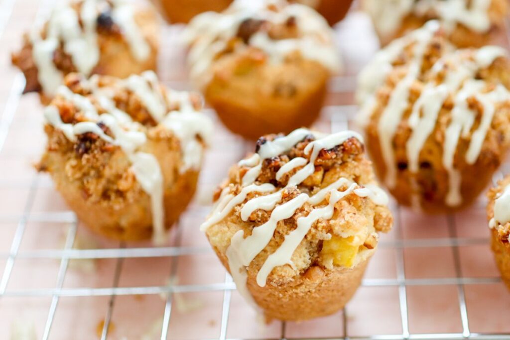 maple and mango muffins resting on a cooling rack
