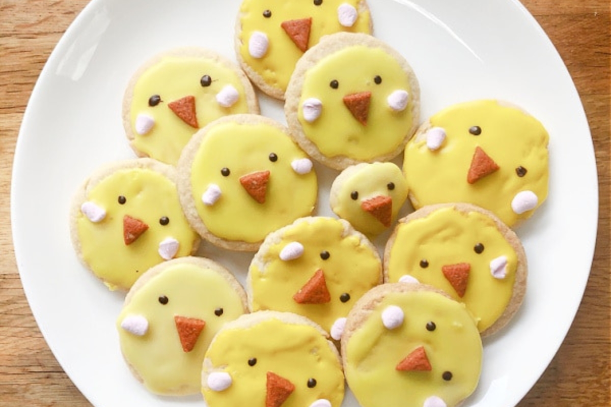 plate of sugar cookies decorated like yellow chicks
