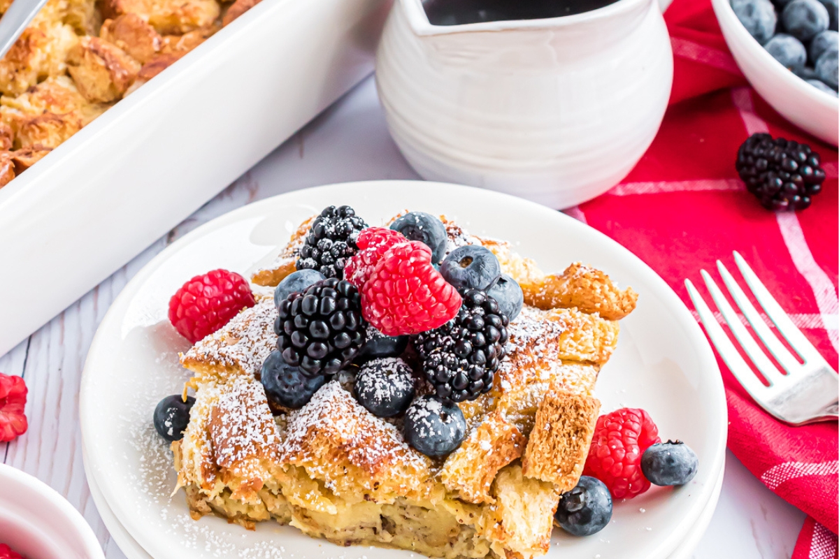 plate with a serving of brioche casserole and fresh berries