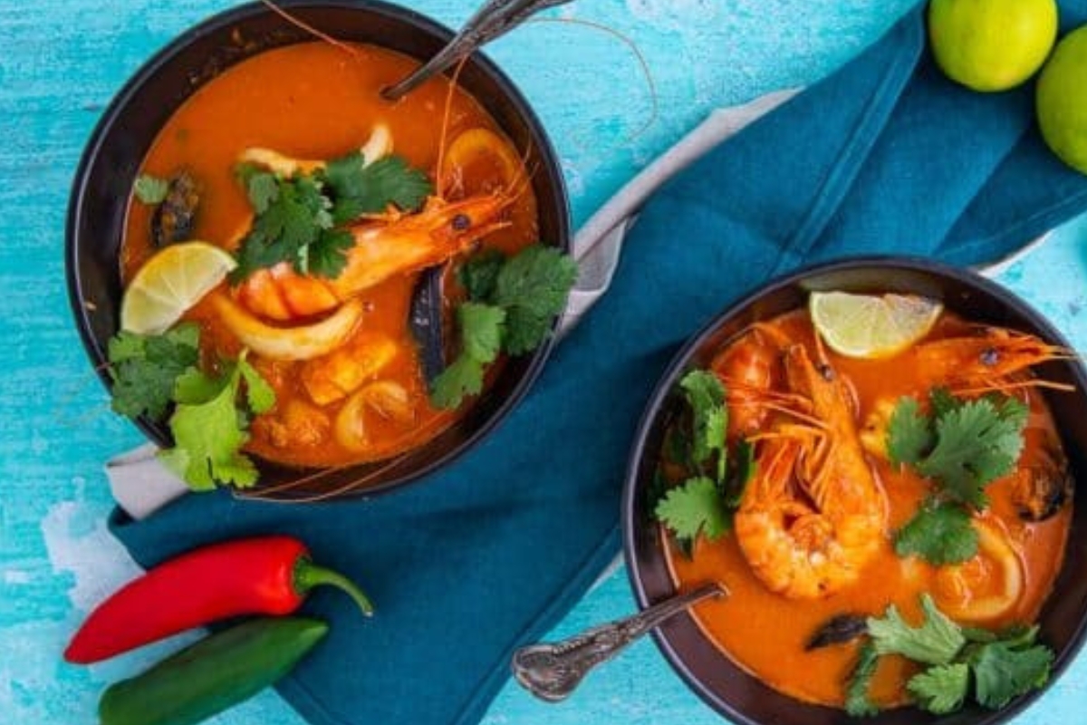 bowls of a colorful seafood soup