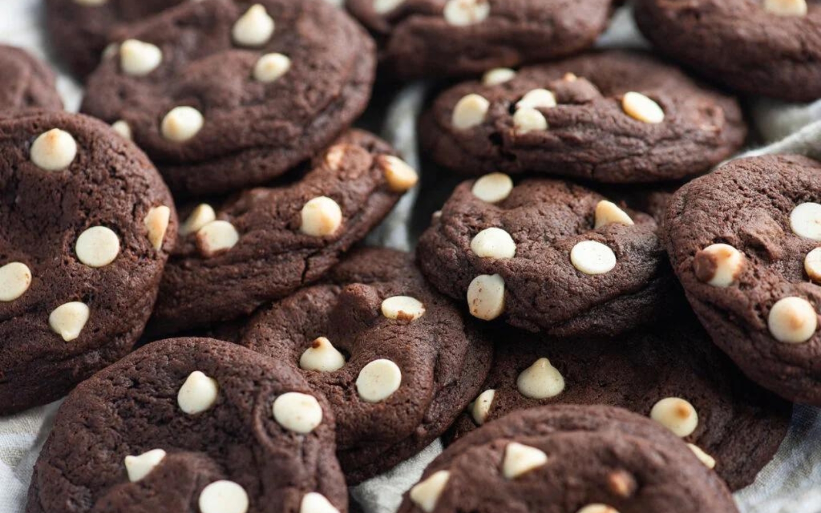 tray of caramel stuffed chocolate cookies with white chocolate chips