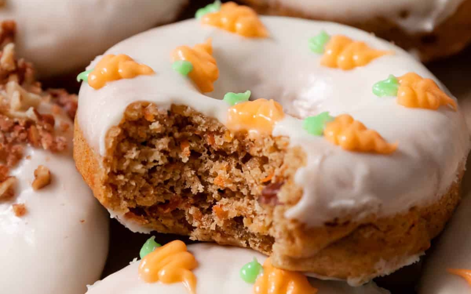 a carrot cake donut with frosting and little carrot decorations