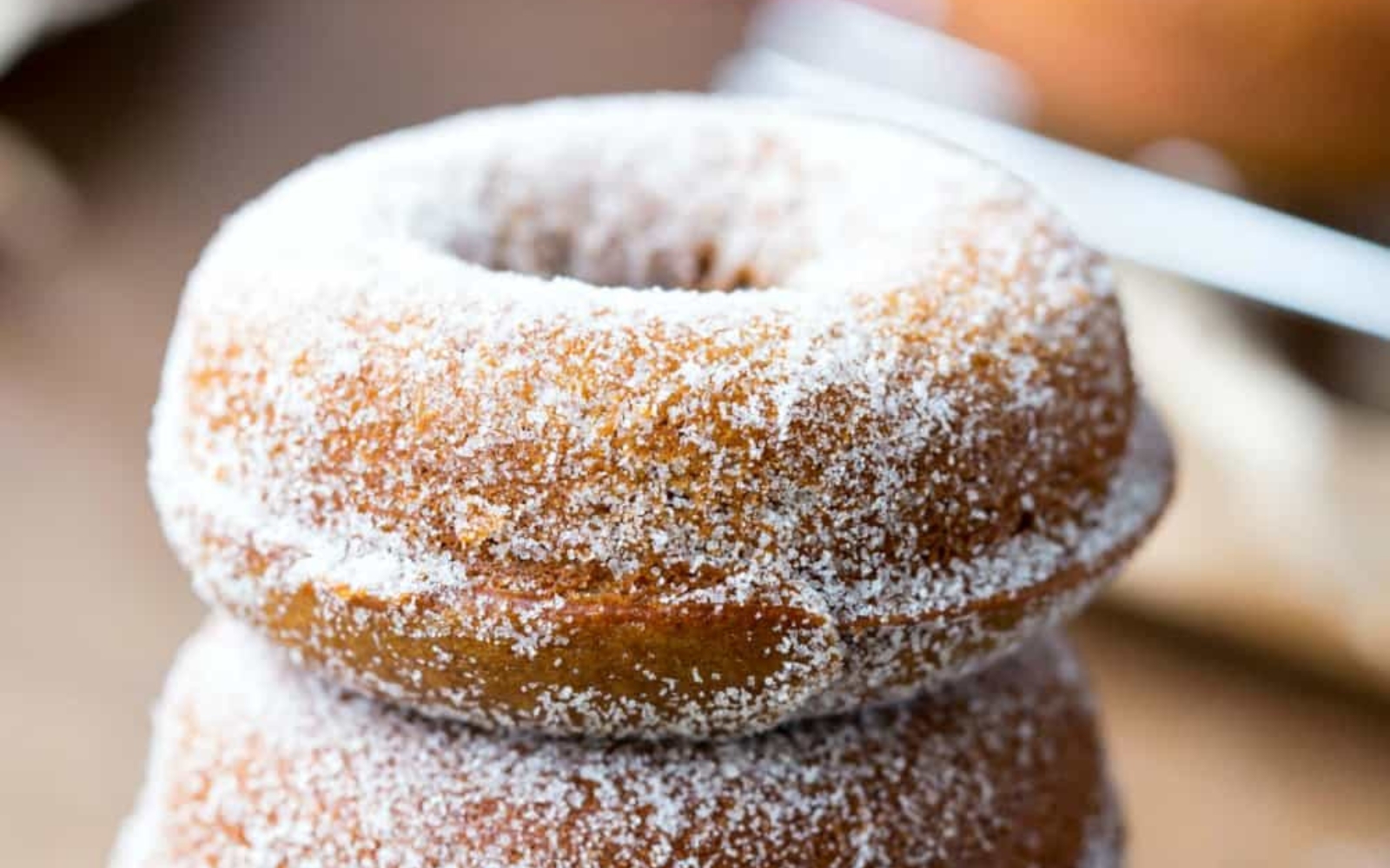 a gingerbread donut sprinkled with sugar
