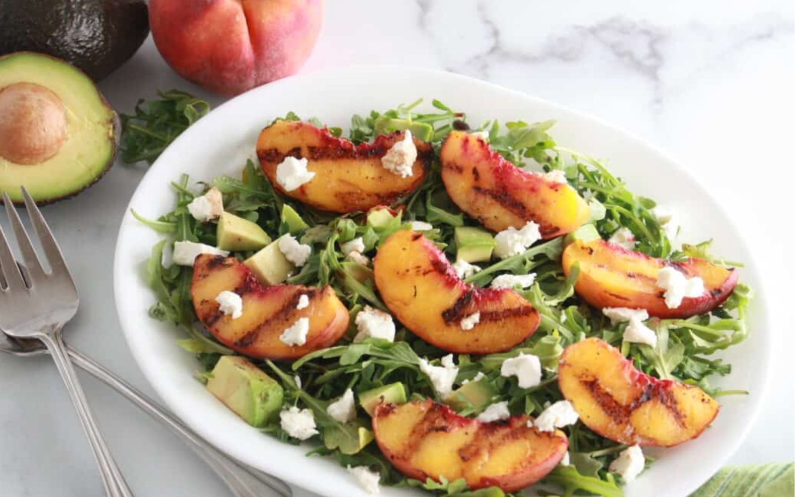 salad on a plate with grilled peaches