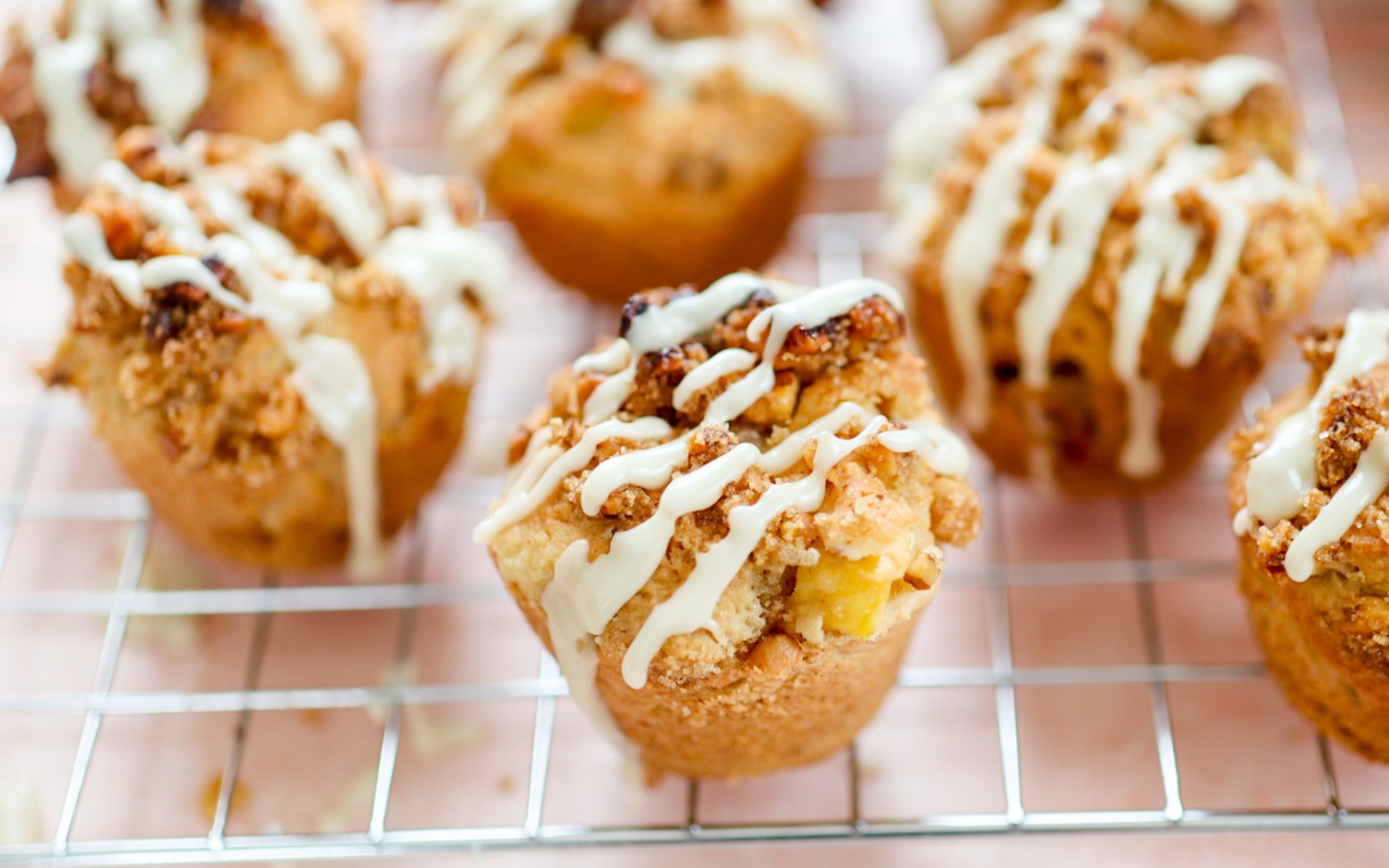 cooling rack full of mango muffins with maple streusel