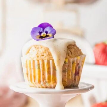 strawberry shortcake muffin topped with a purple violet