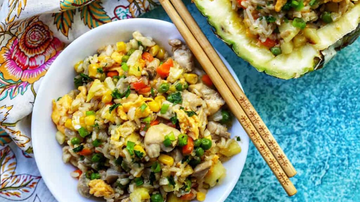 Pineapple fried rice served in plate with chopsticks