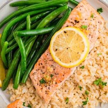 baked salmon on a plate with green beans and rice