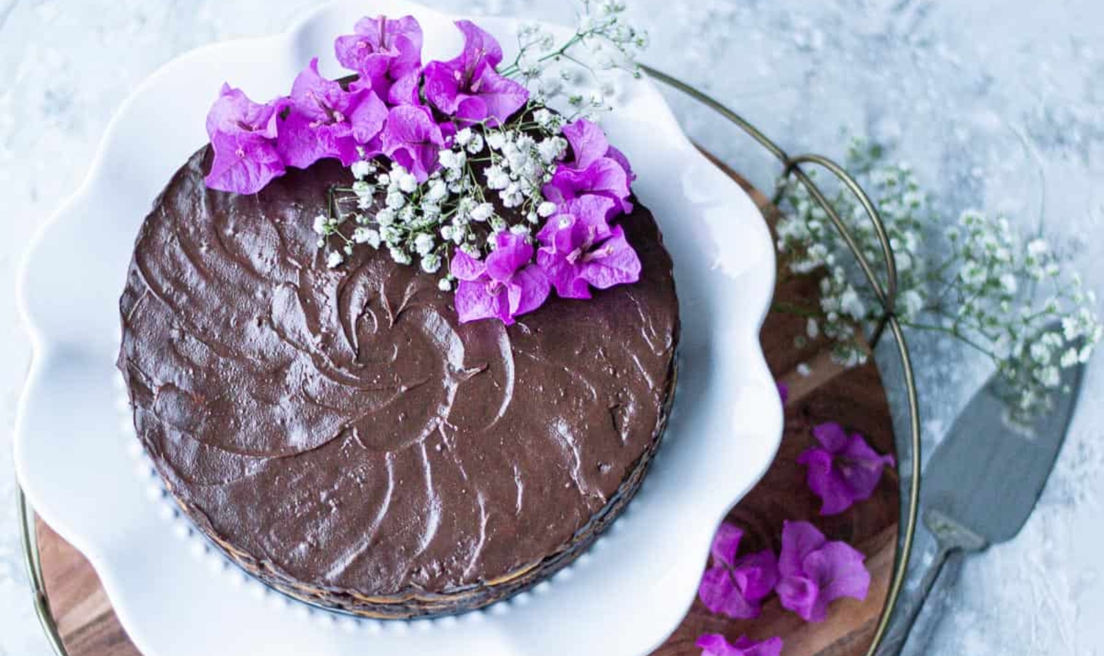 a beautiful chocolate tart decorated with purple flowers