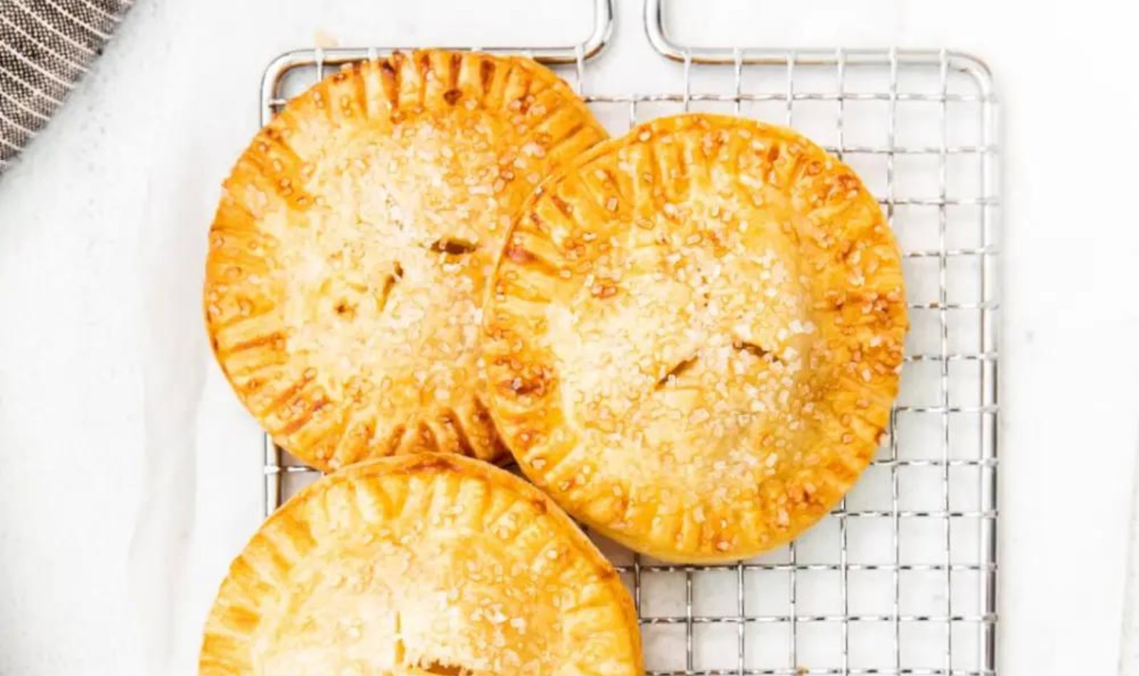 a cooling rack with apple hand pies