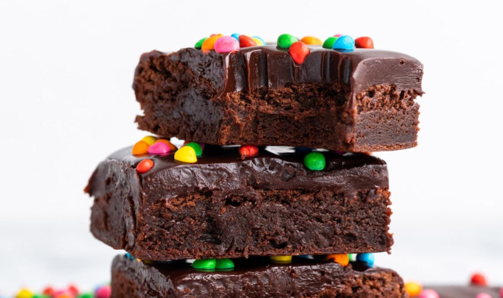 a stack of cosmic brownies with mini m&ms on top