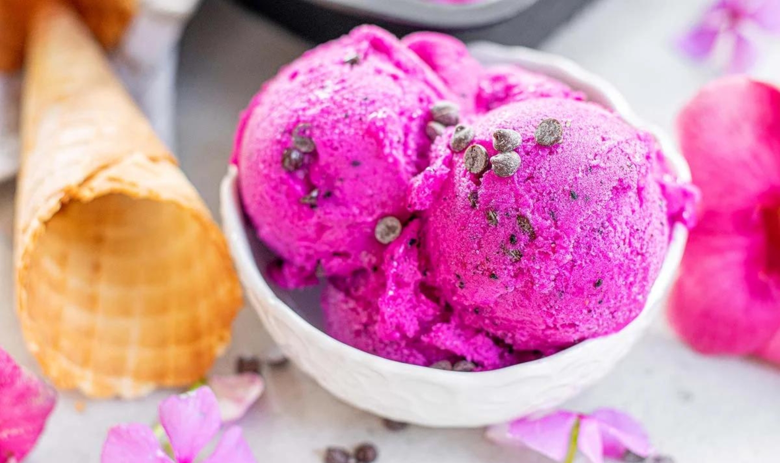 a bowl full of pink dragon fruit ice cream
