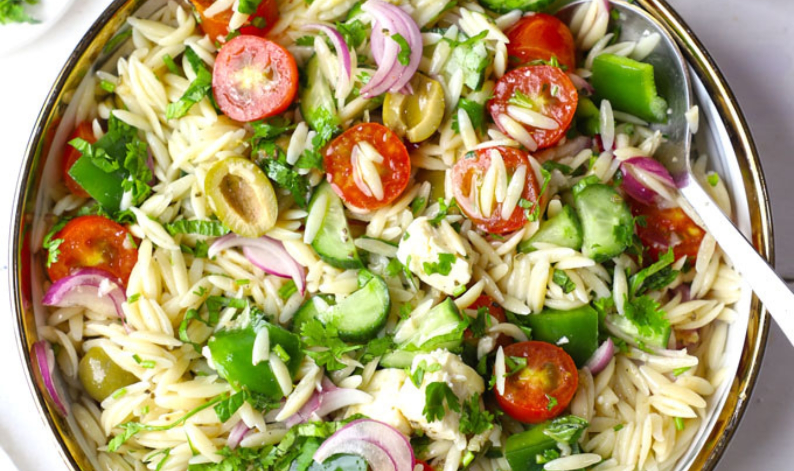 a bowl of Greek pasta salad