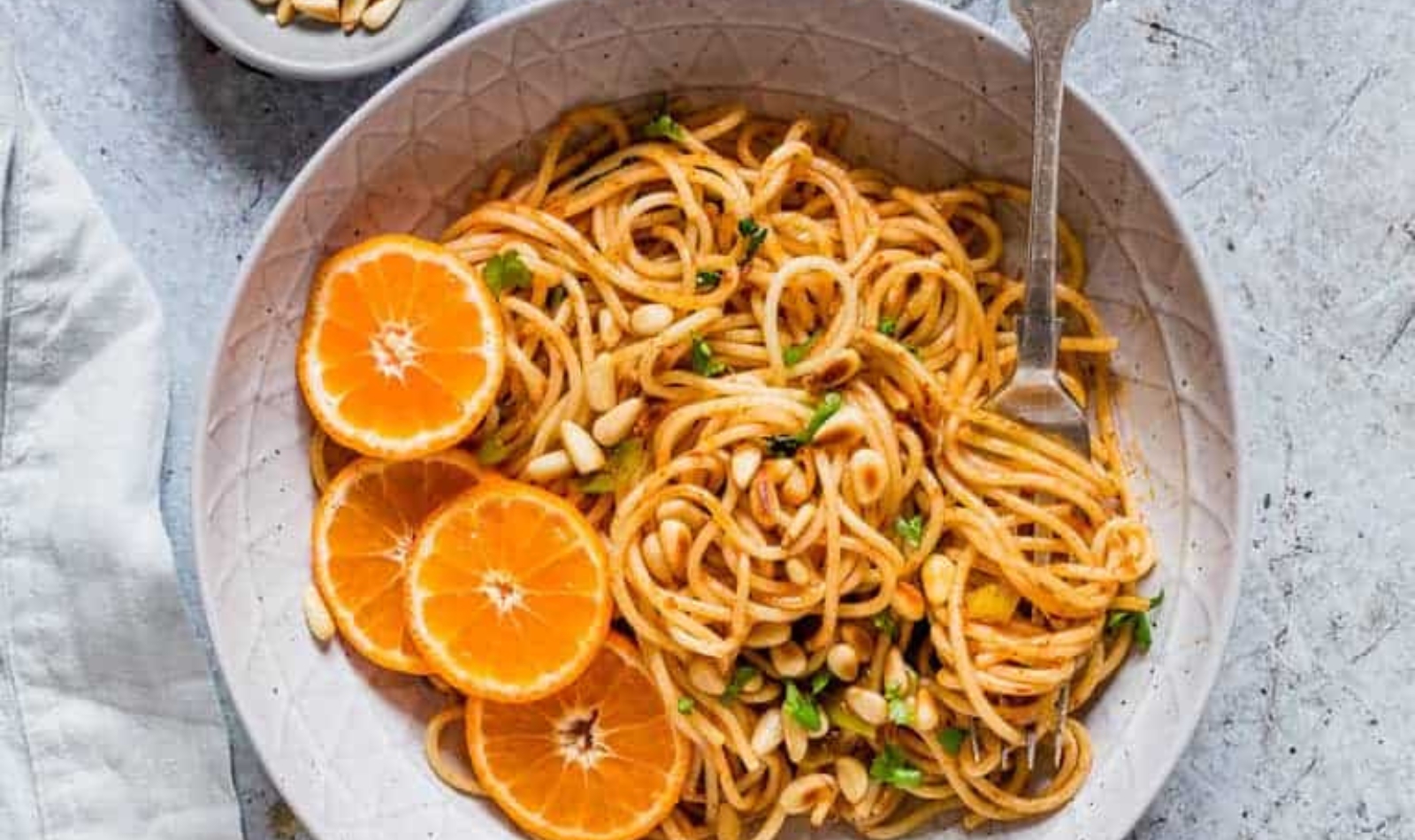 a plate of orange harissa pasta