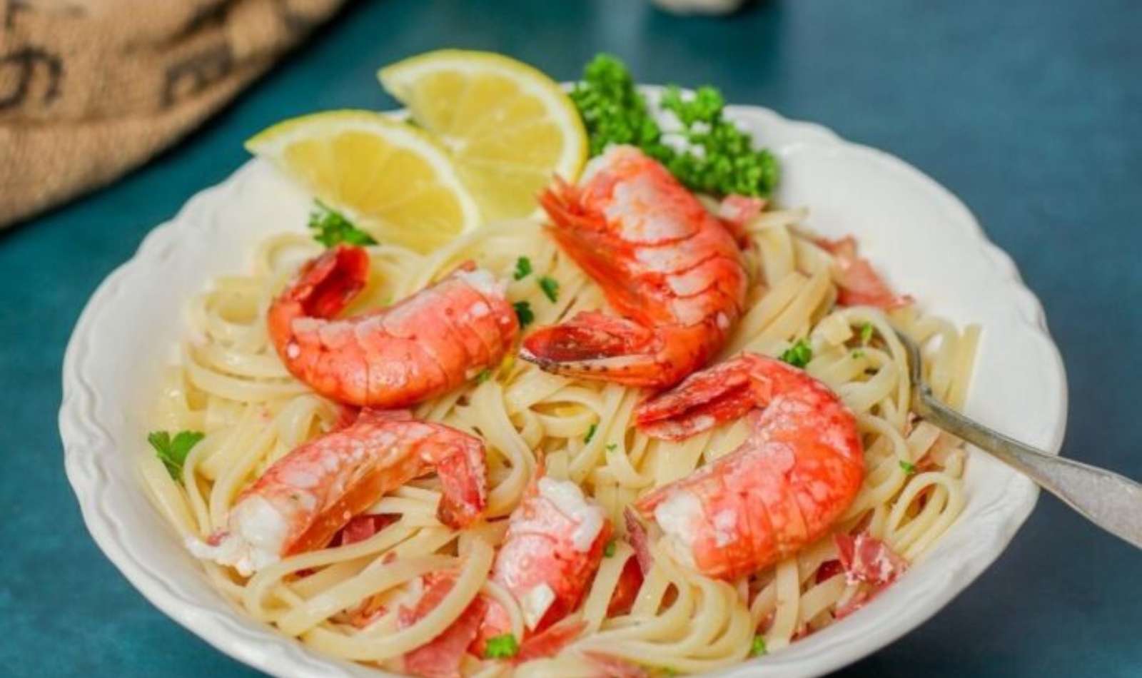 a plate of linguini with spot prawns