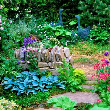 a whimsical garden with stone wall