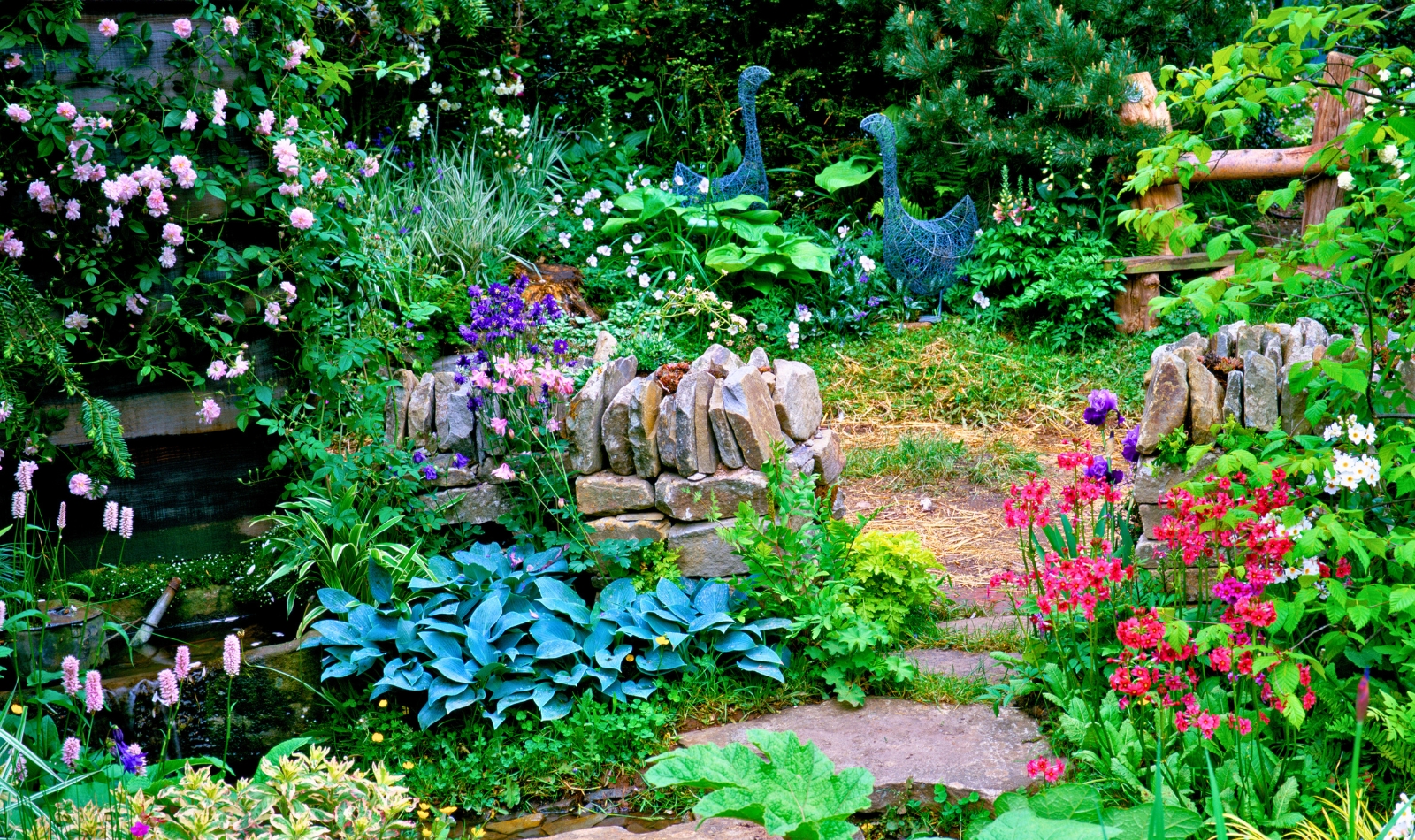 a whimsical garden with stone wall