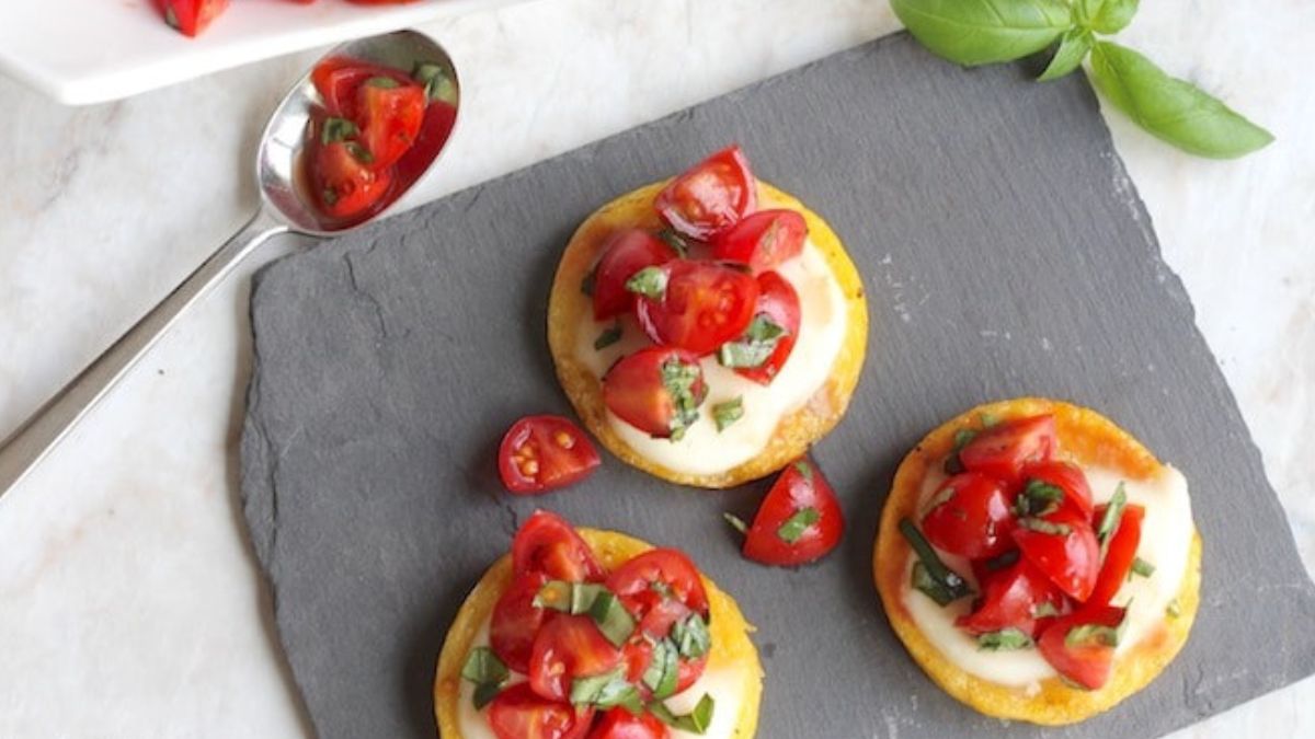 Grilled polenta topped with fresh tomatoes and mozzarella