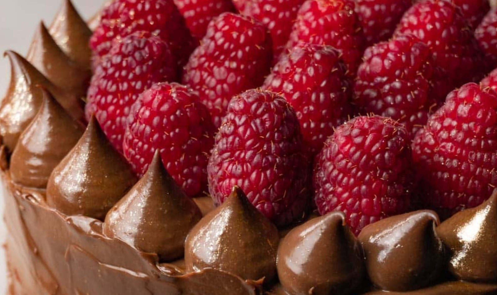 Image of chocolate frosted cake with strawberries on top