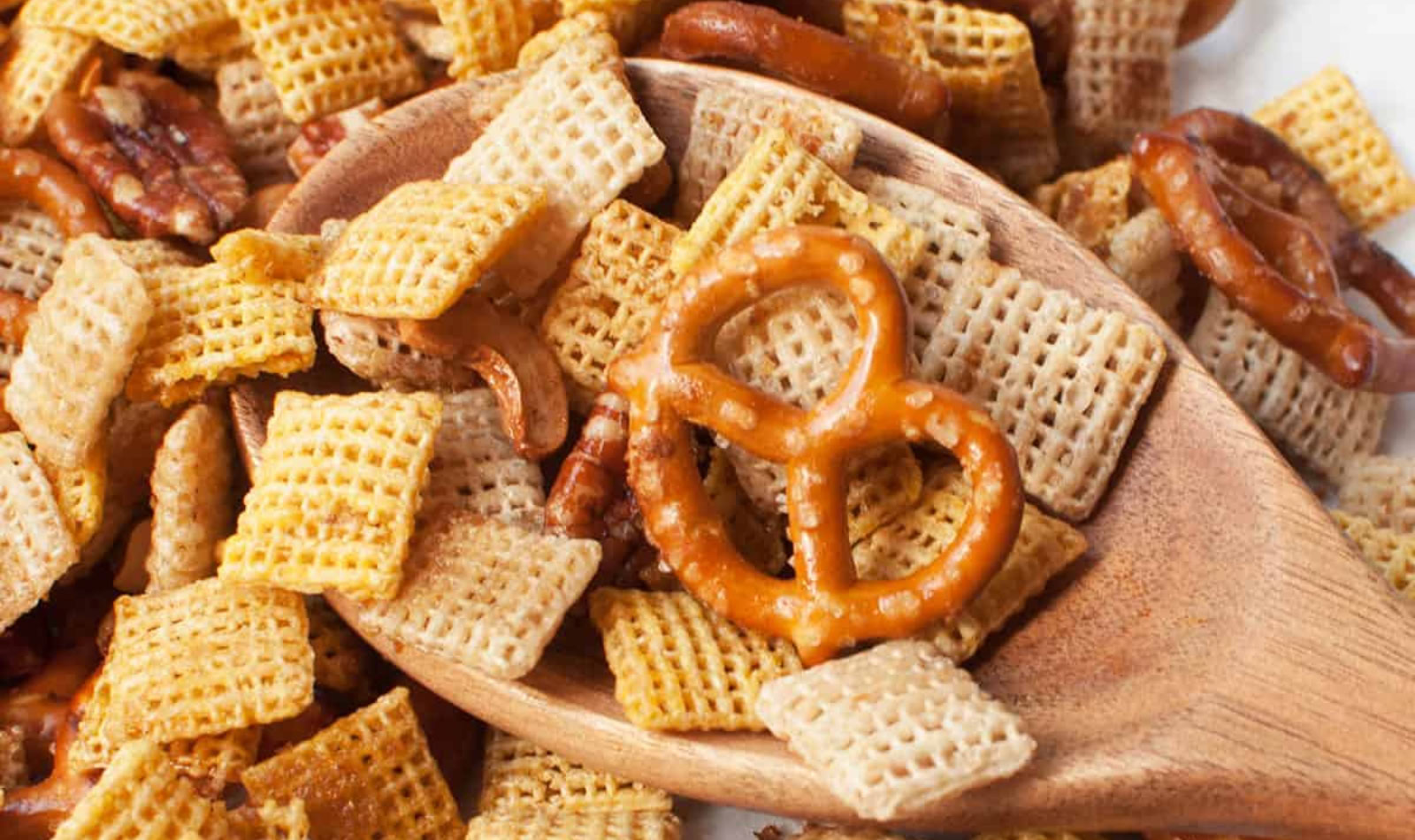 chex mix with a wooden spoon