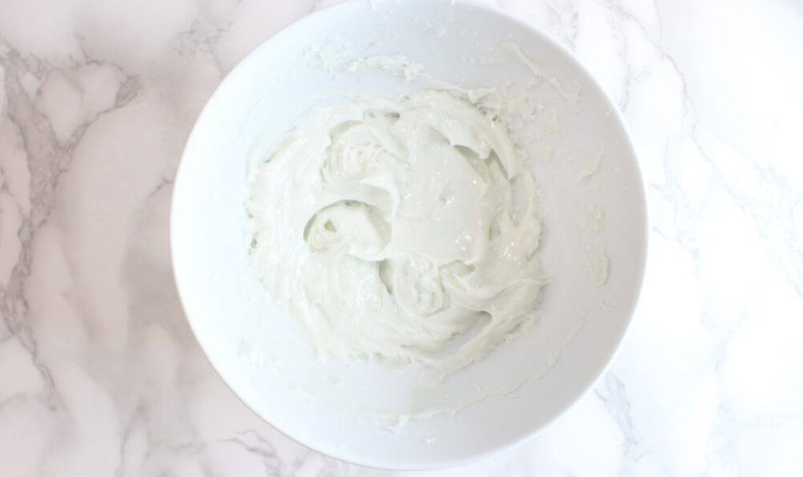 Image of white bowl on white marble countertop containing a creamy white substance