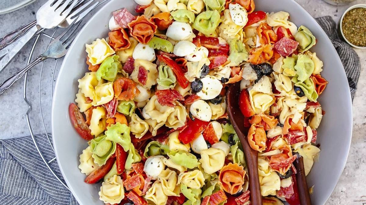 Tortellini Salad served with wooden spoons