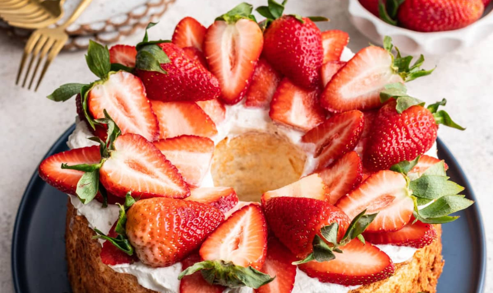 angel food cake with frosting and strawberries