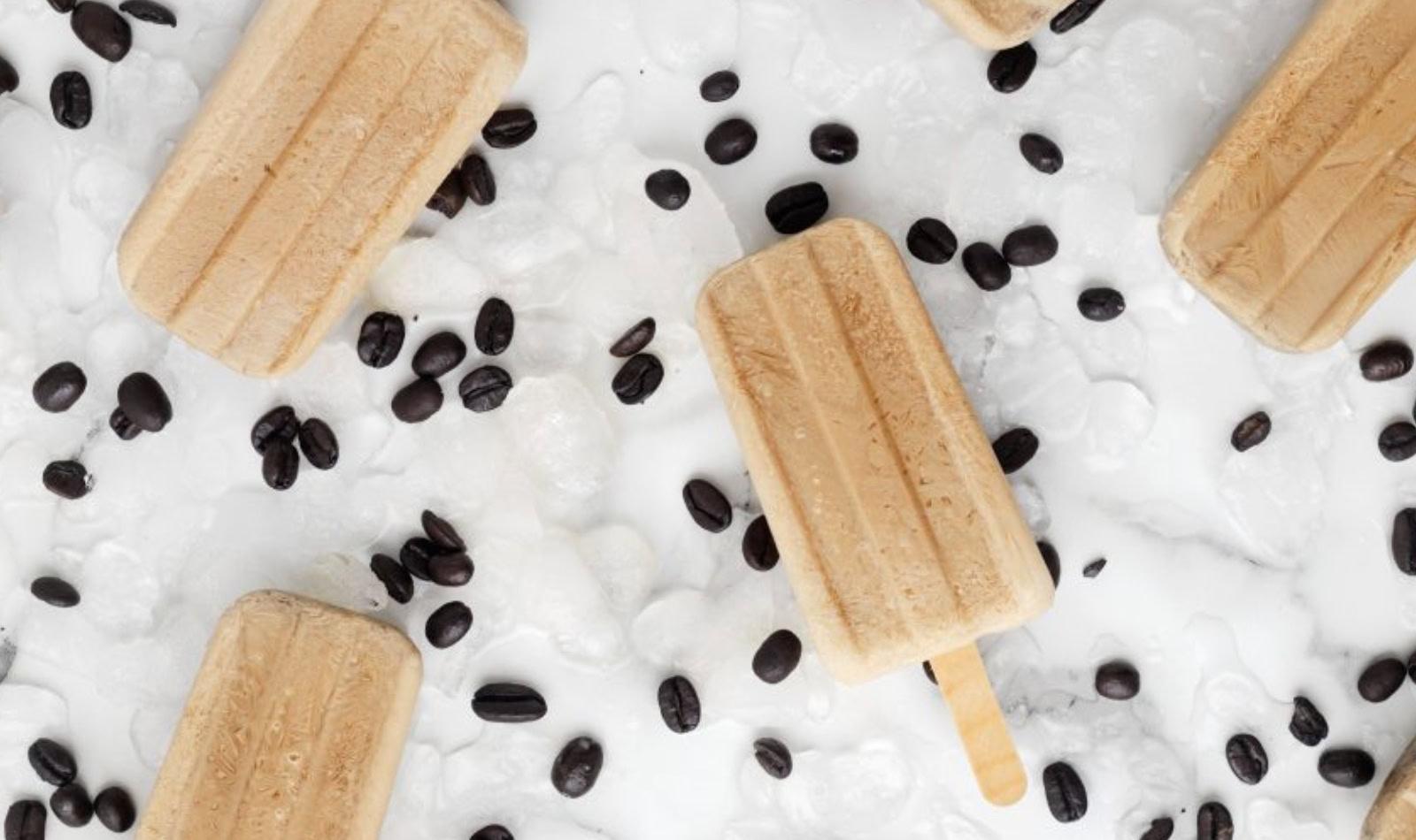 an icy tray with coffee beans and coffee pops