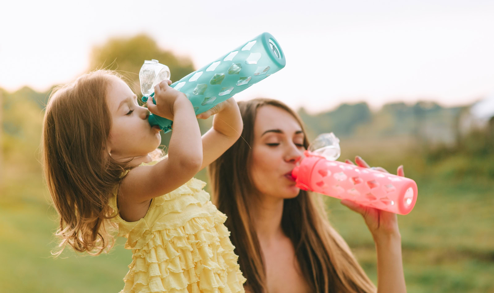 mom and daughter drinking water