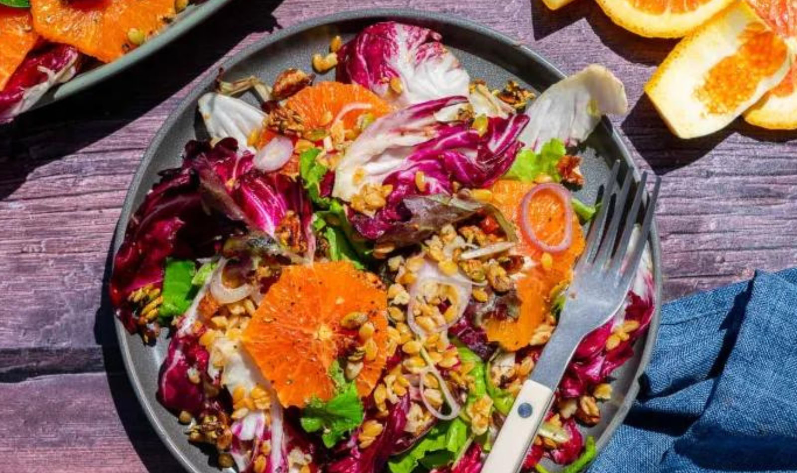 a plate of salad with einkorn, radicchio, and oranges. 