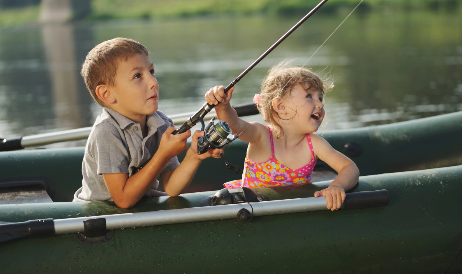 two kids fishing in a boat