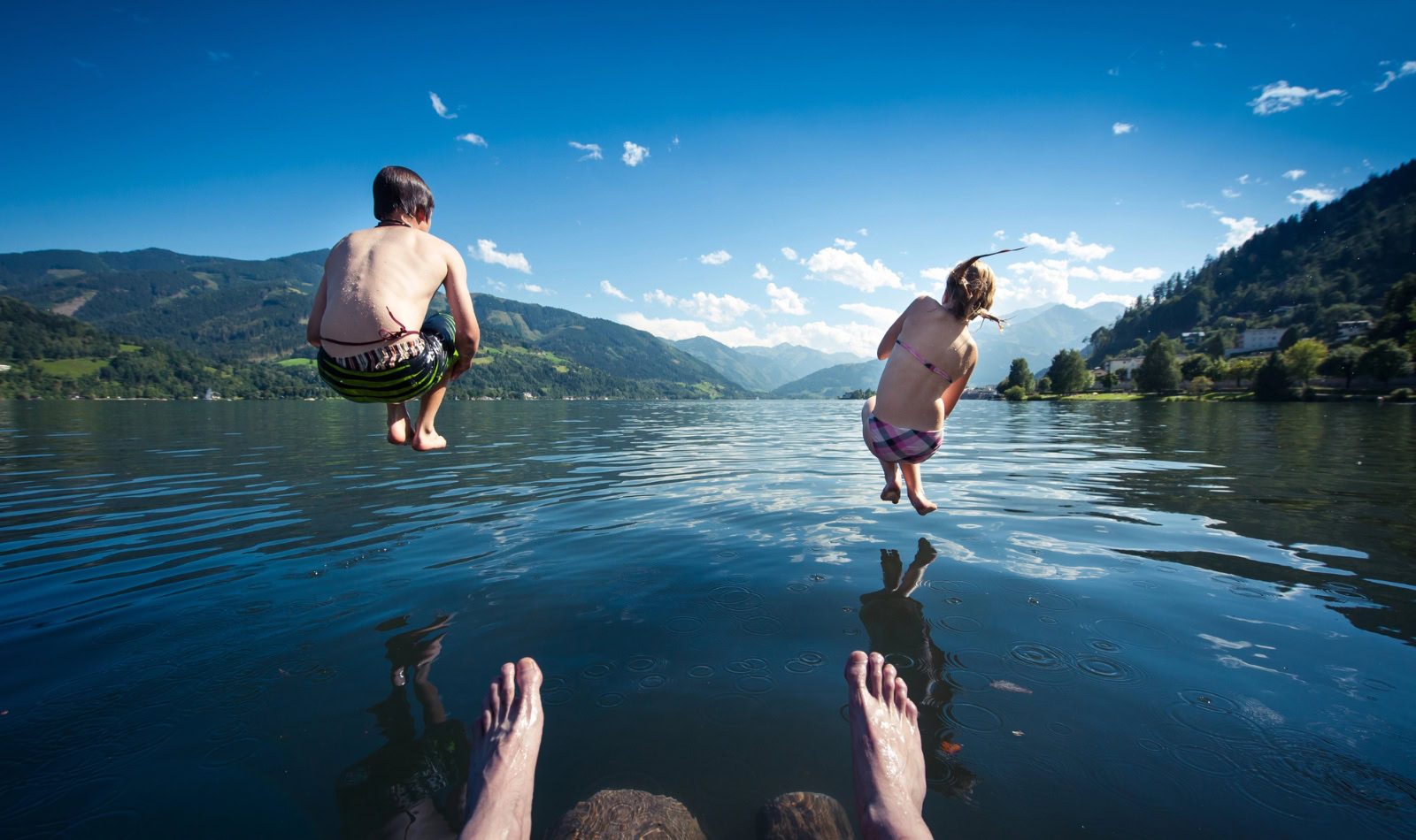 kids jumping in a lake