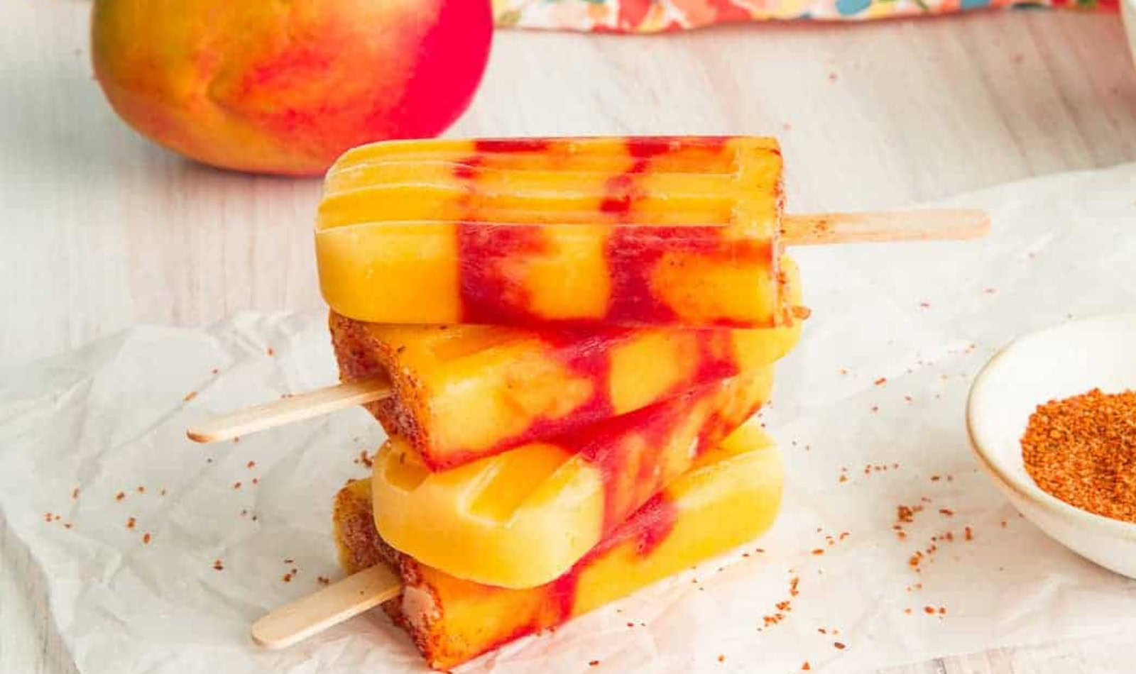 mango rosewater popsicles in a stack