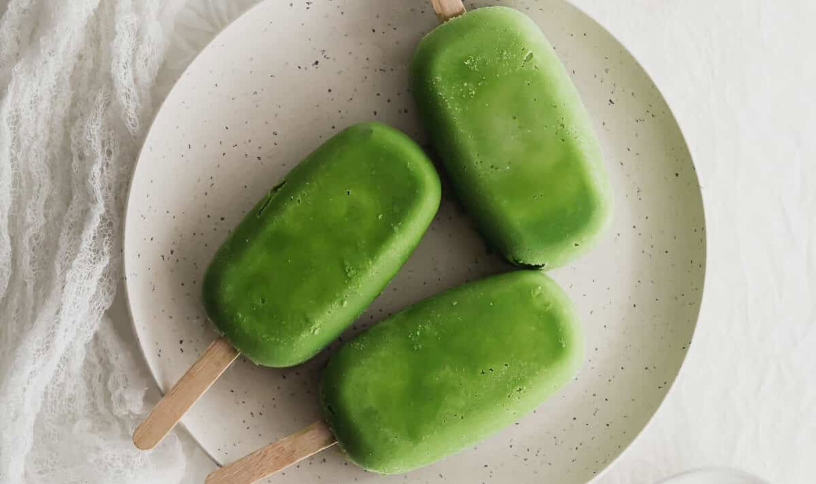 a plate with matcha popsicles