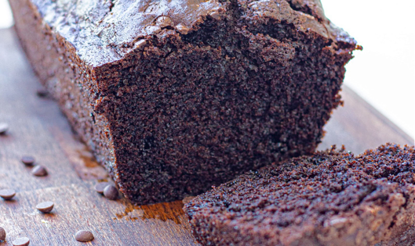 Image of dark chocolate pound cake on a cutting board. 