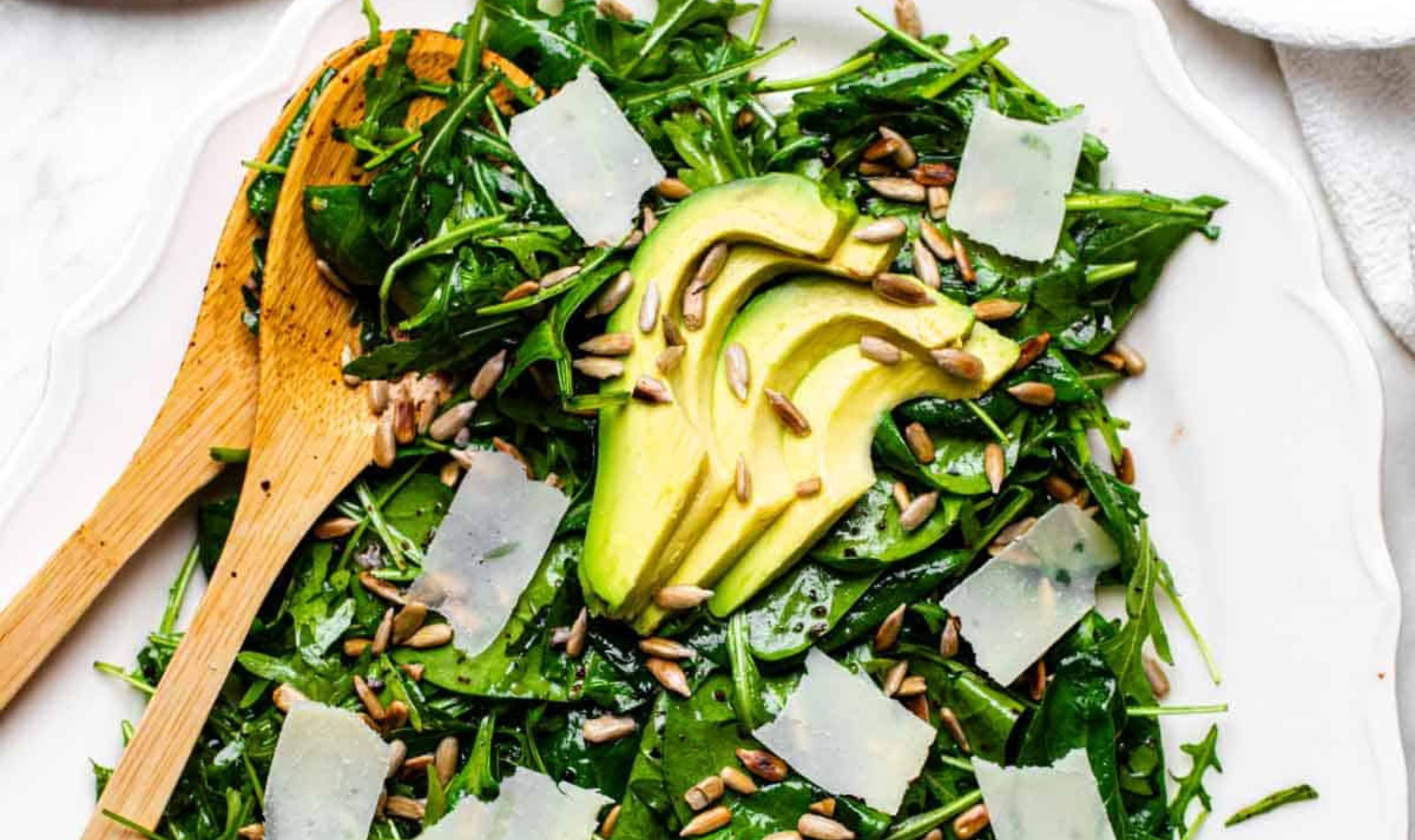 a serving dish of spinach arugula salad