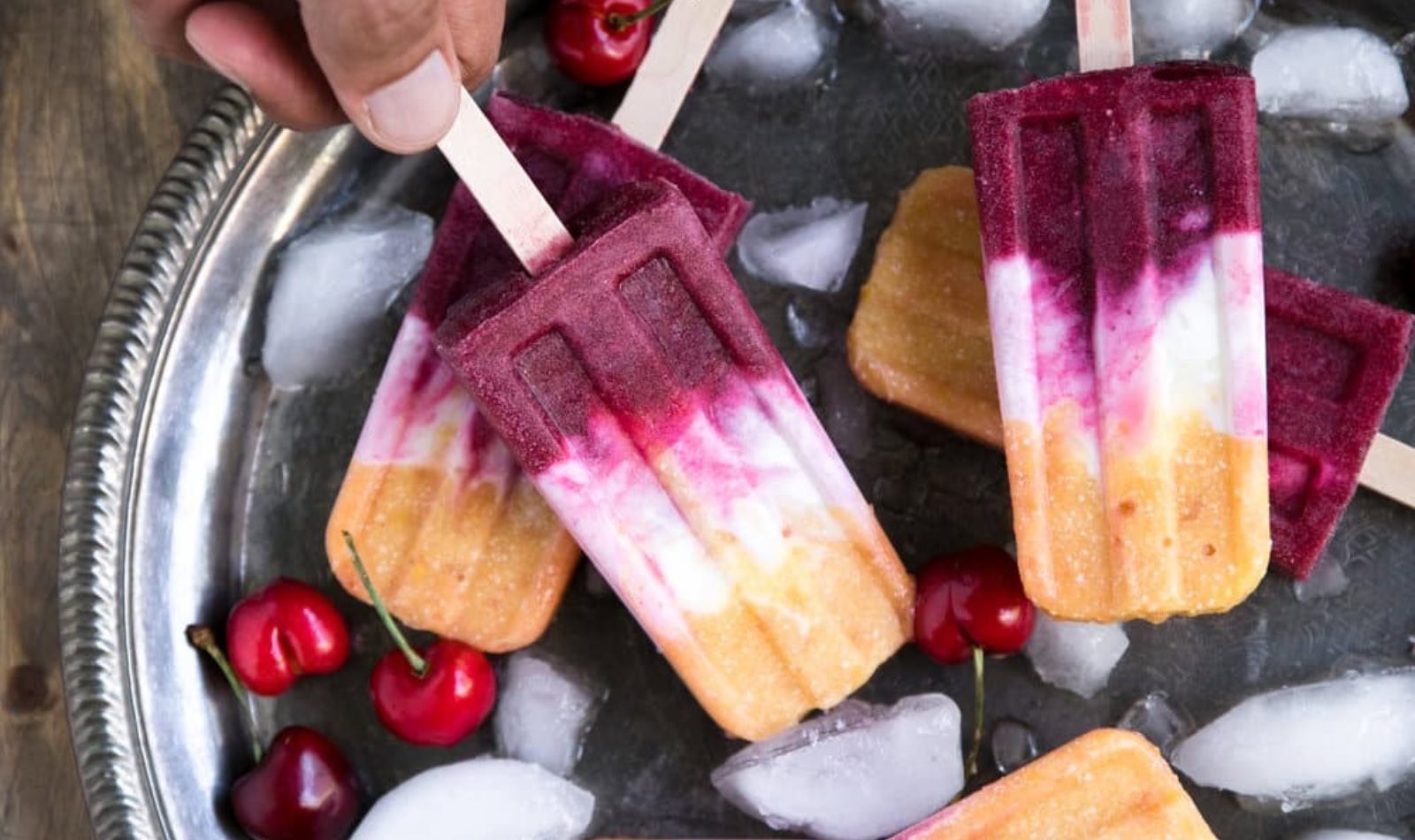 a tray with peach and cherry popsicles