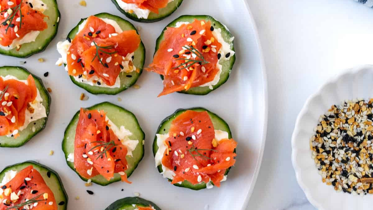 Cucumber and salmon bites served with sesame seeds