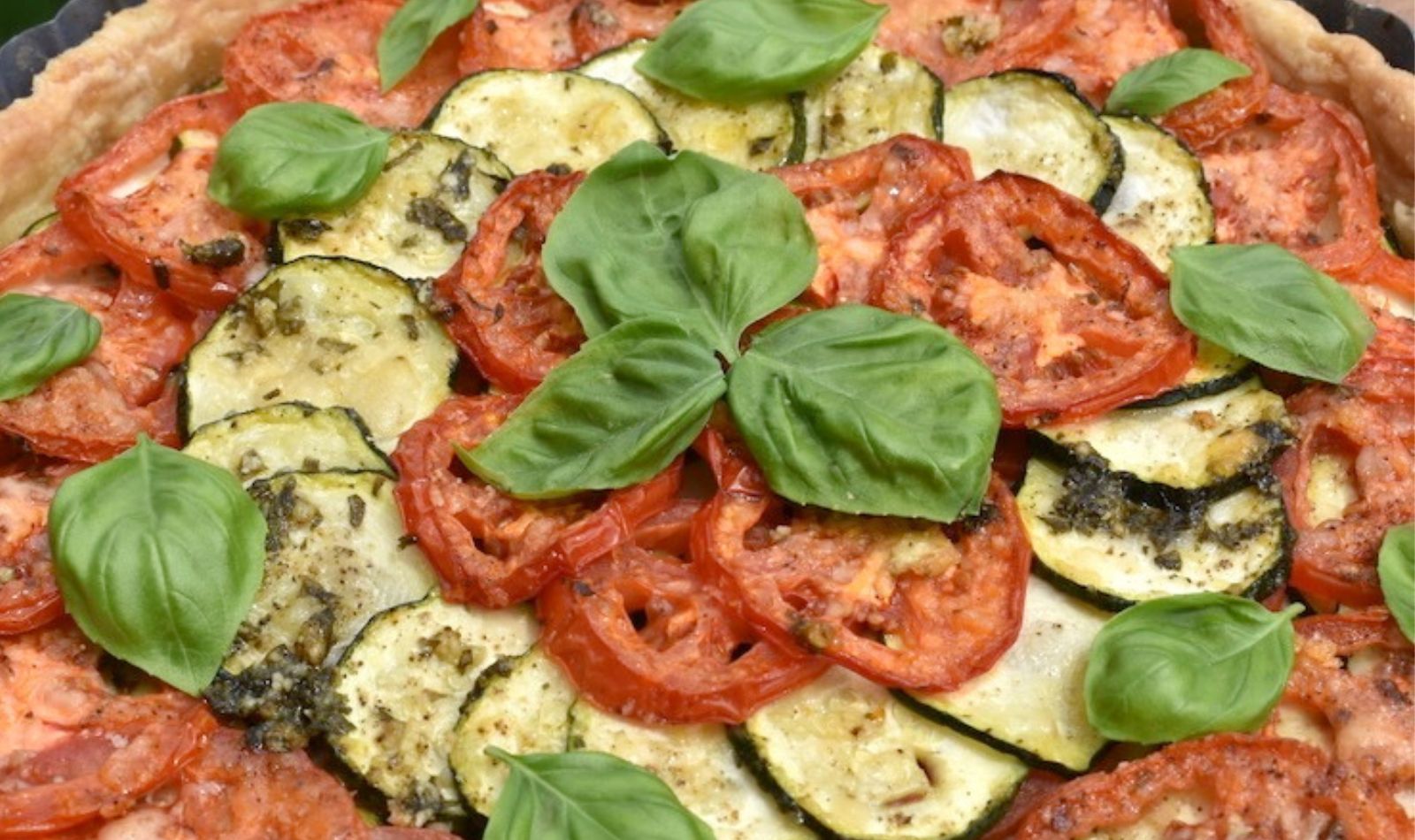 zucchini-and-tomato-tart garnished with herbs