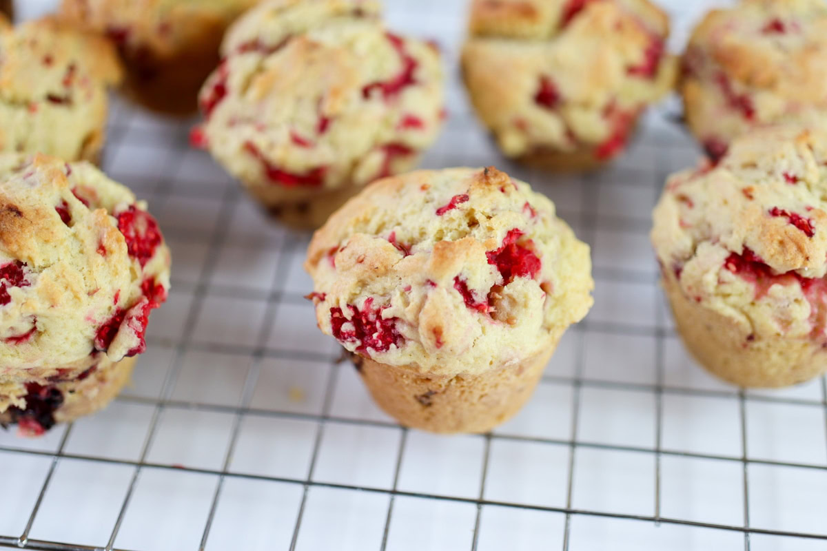 raspberry muffins on a cooling rack