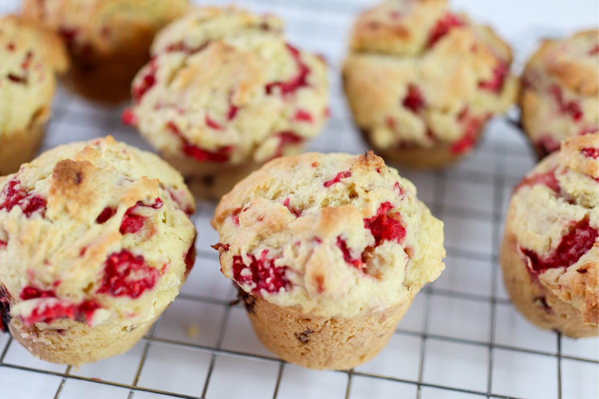 raspberry muffins on a cooling rack