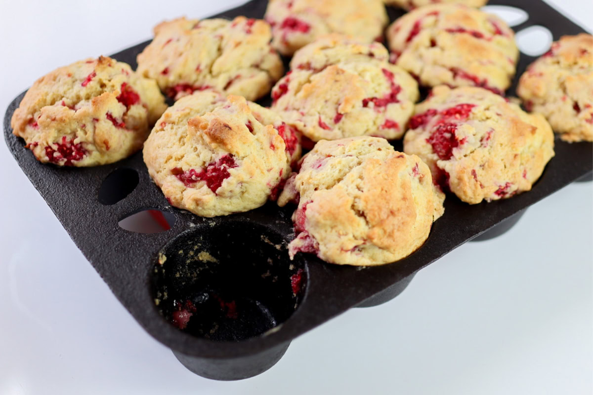 raspberry muffins in a cast iron muffin pan