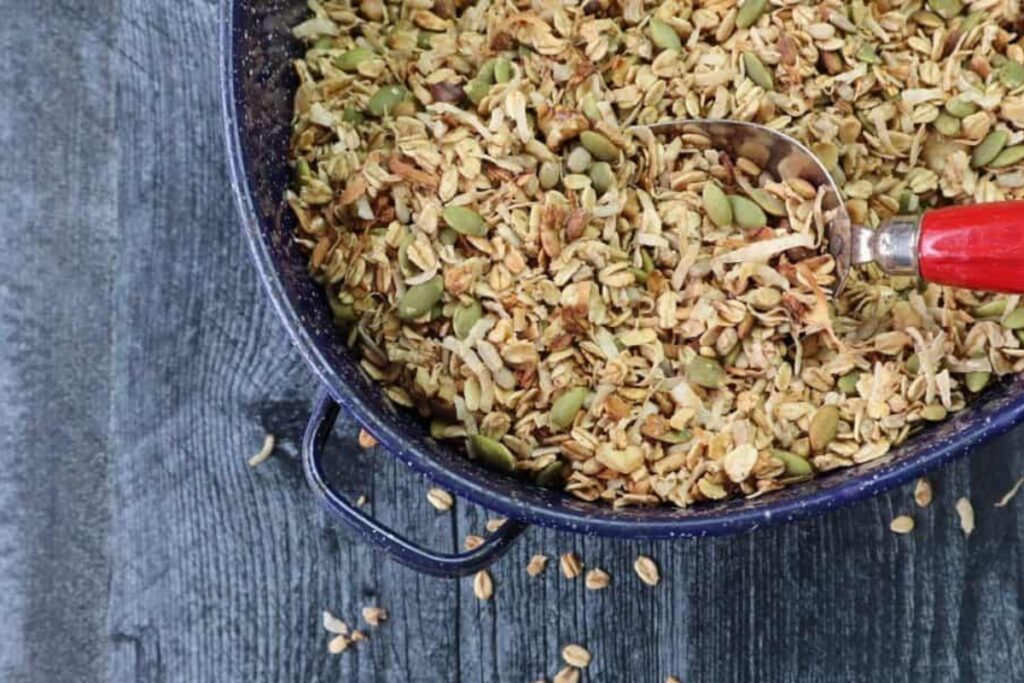 a blue roasting pan full of granola