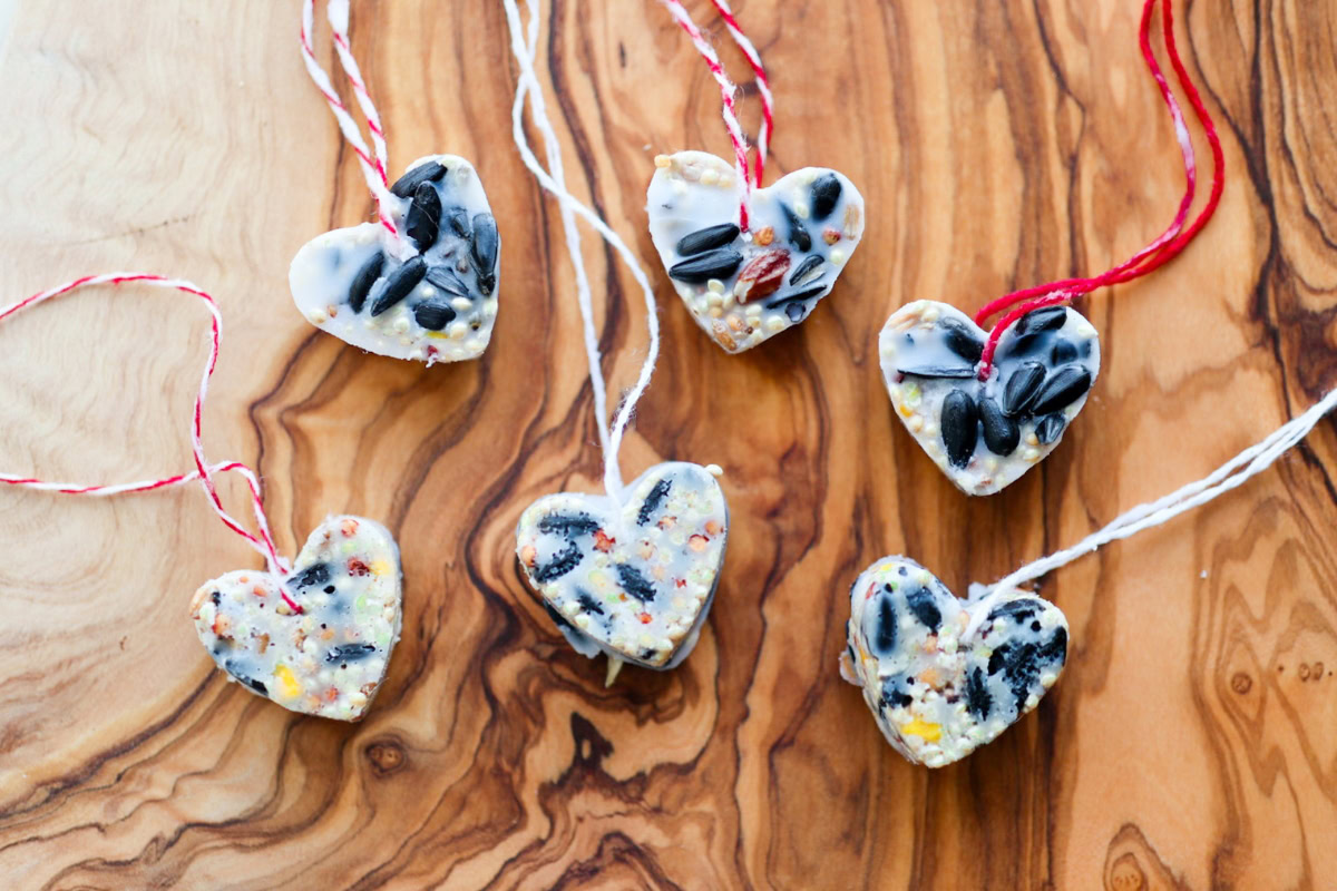 birdseed valentines on a wooden cutting board